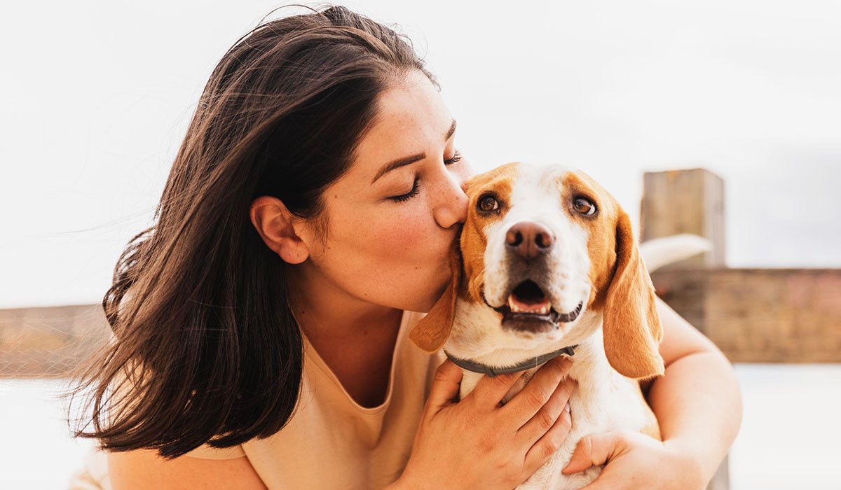 female-kissing-dog-human-animal-bond